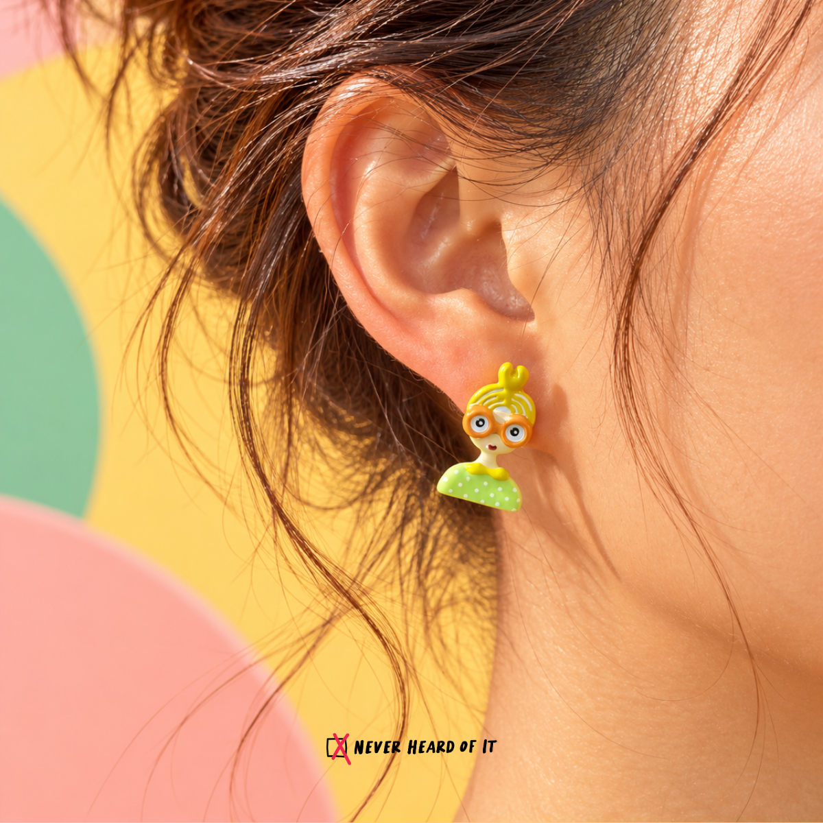 Big Eyes Club Mismatched Enamel Studs — Yellow Bun worn on an ear